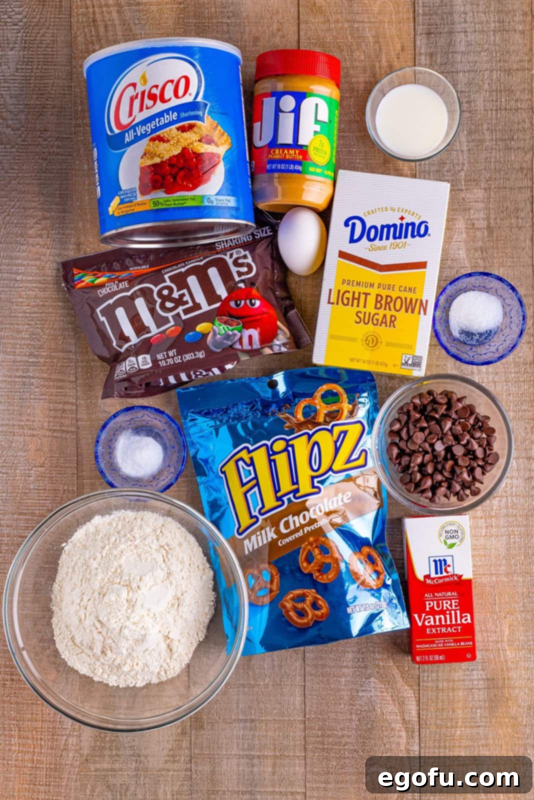 Red Nosed Reindeer Treats 4 ingredients: crisco, light brown sugar, peanut butter, milk, vanilla extract, egg, all purpose flour, baking soda, mini pretzel twists, M & M chocolate candy and chocolate chips.