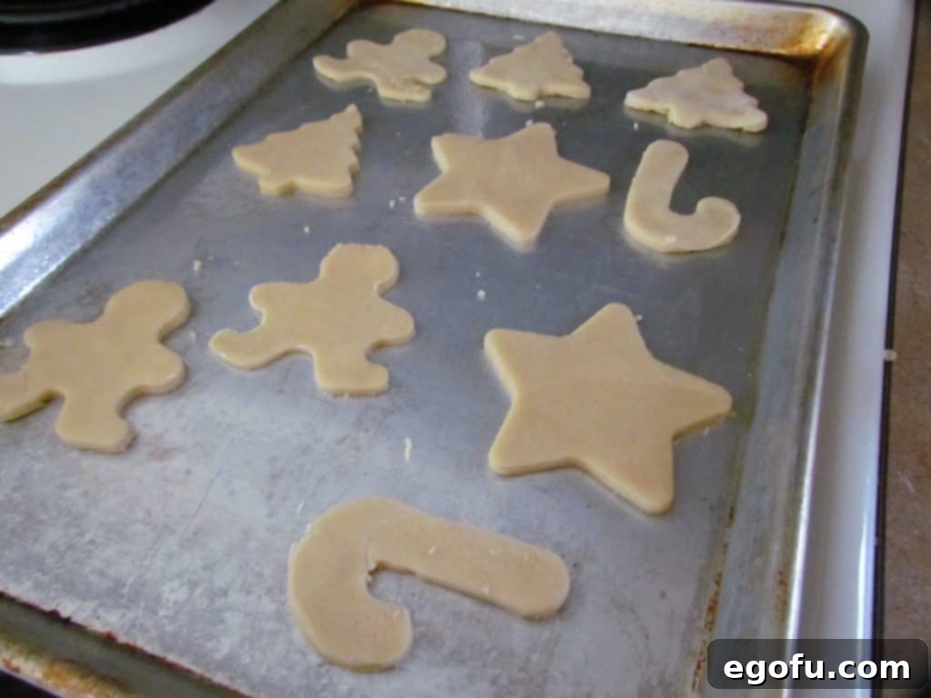 cut out sugar cookie Christmas sheets shown on a baking sheet