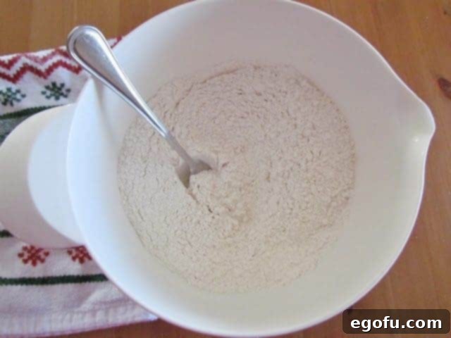 fork inside flour mixture in a white bowl