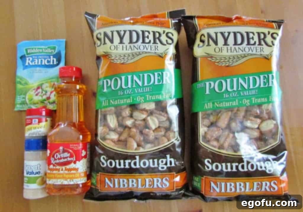 All the ingredients for Ranch Pretzel Bites laid out: pretzels, butter-flavored popcorn oil, ranch mix, dill weed, and garlic powder.