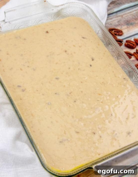 pecan praline batter poured into a baking dish.