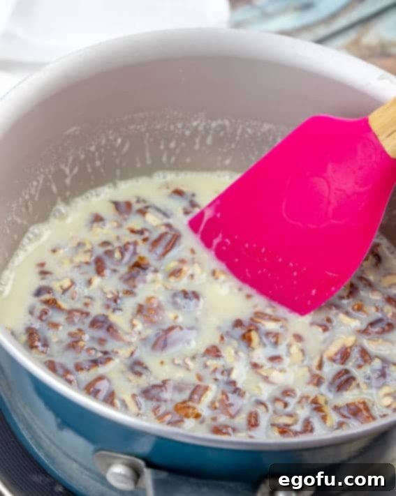 chopped pecans added to butter and sweetened condensed milk in a sauce pan.