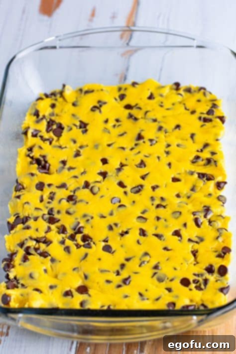 Unbaked Chocolate Chip Cookie Bars in a baking dish.