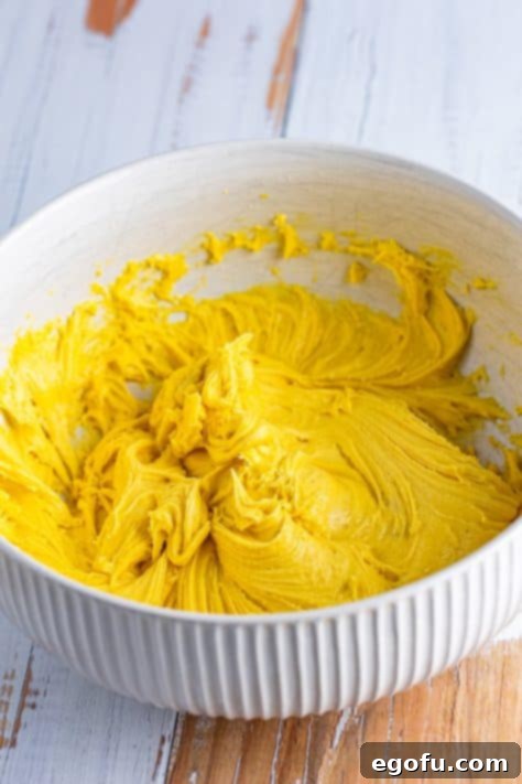Yellow cake mix batter in a bowl.
