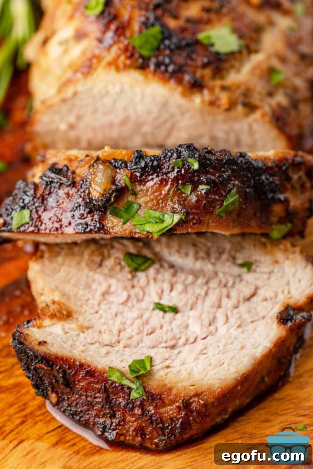 Overhead shot of a perfectly cooked Air Fryer Pork Tenderloin, sliced to reveal its juicy interior.