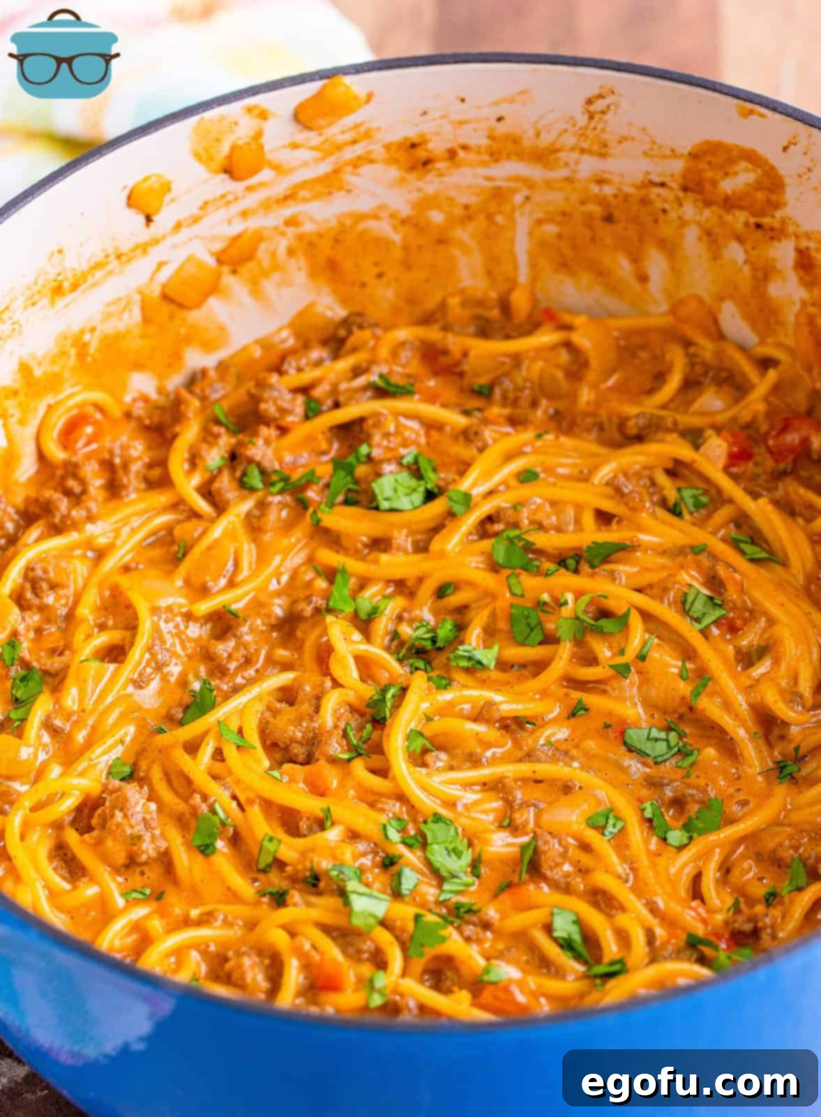 The finished One Pot Taco Spaghetti, garnished with fresh cilantro, served directly from the Dutch oven.
