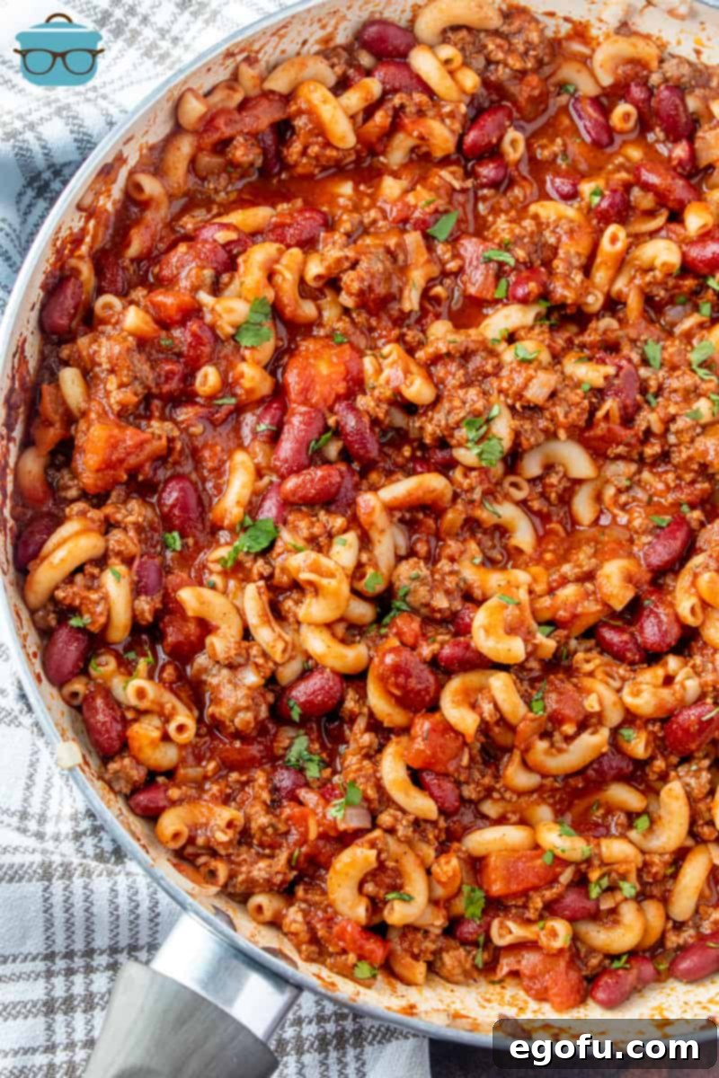 finished, The Best Chili Macaroni recipe in a large skillet topped with parsley flakes, ready to be served.