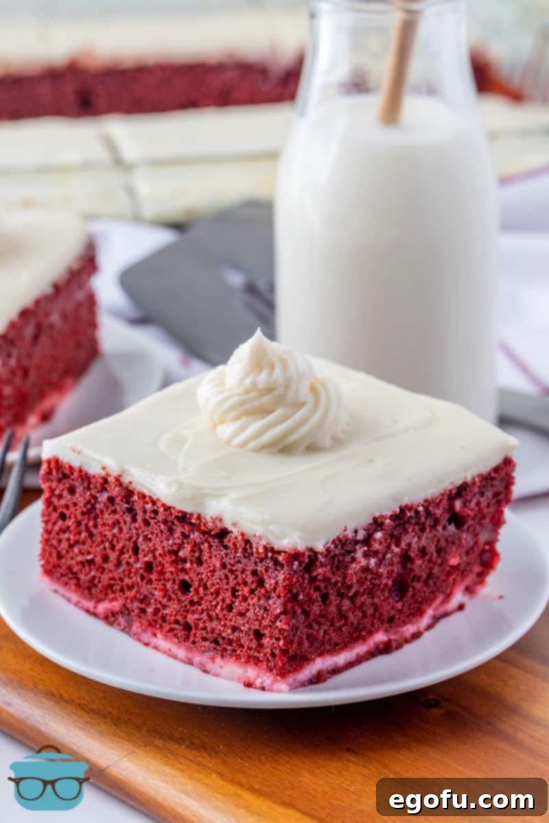 Red Velvet Cheesecake Fusion 2 a slice of red velvet cheesecake cake on a round white plate.