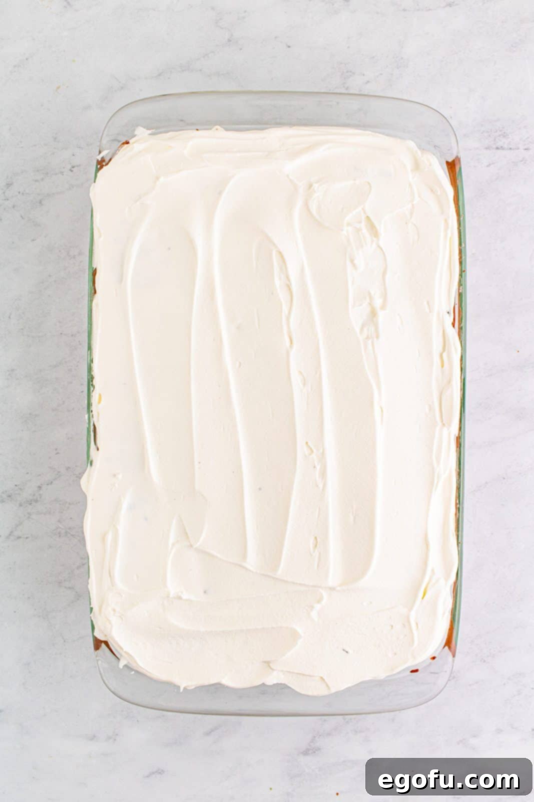 Easy No-Bake Swiss Roll 13 Remaining whipped cream spread over top of cut swiss cake rolls.