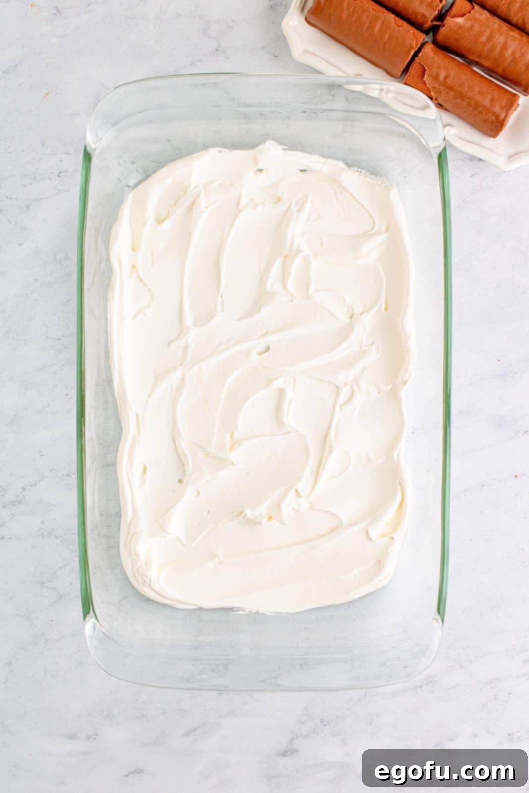 Easy No-Bake Swiss Roll 6 Cool whip spread in bottom of baking dish.