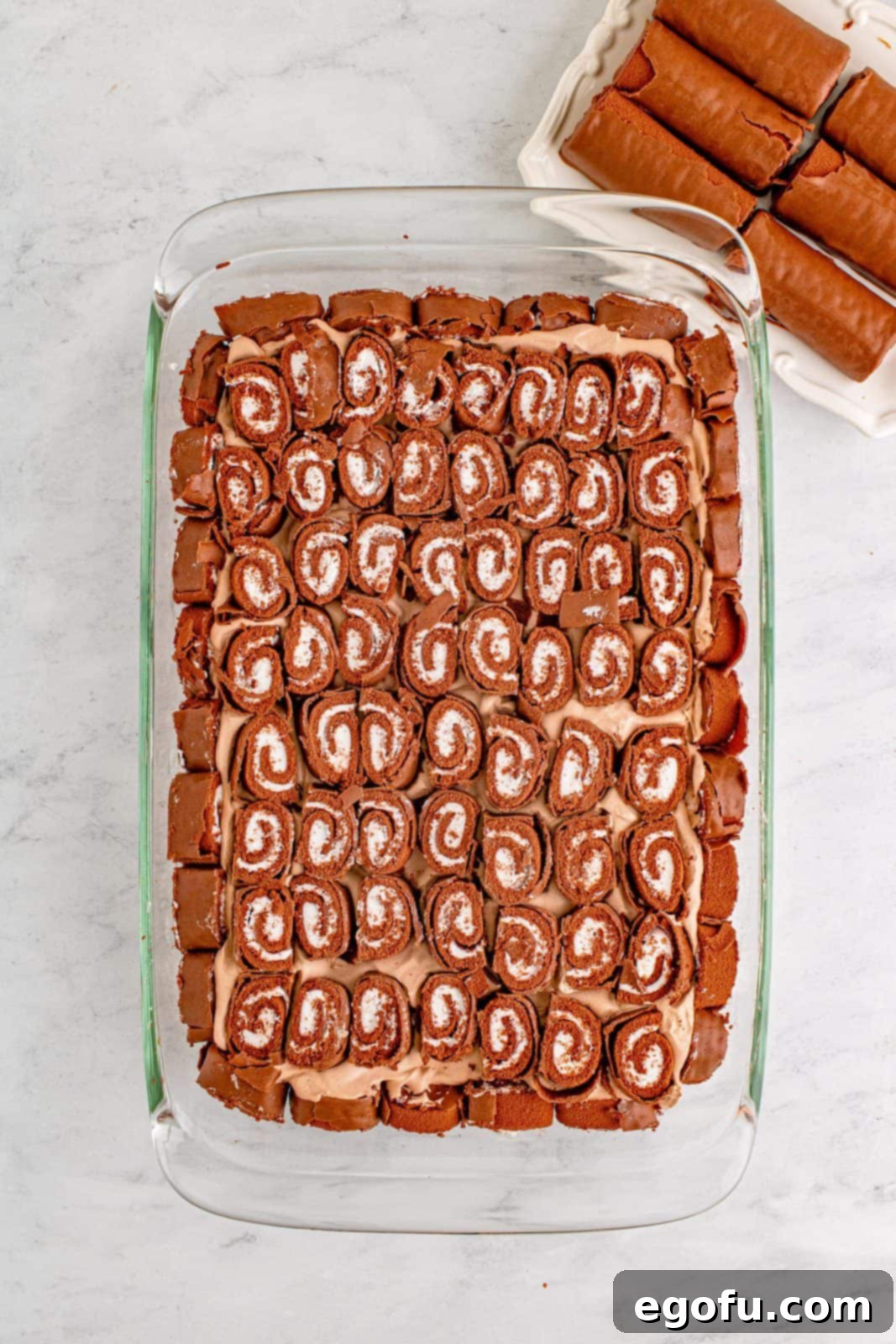 Easy No-Bake Swiss Roll 10 Cut swiss cake rolls placed on top of the