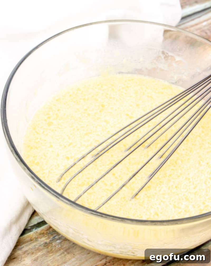 Decadent Milk Chocolate Chip Muffins 6 eggs, oil and water whisked together in a mixing bowl.