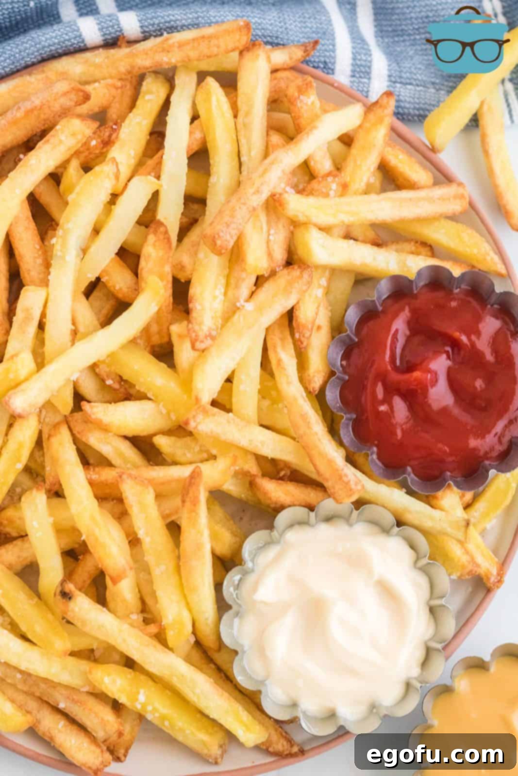 Air Fryer Frozen French Fries on platter with dipping sauces.