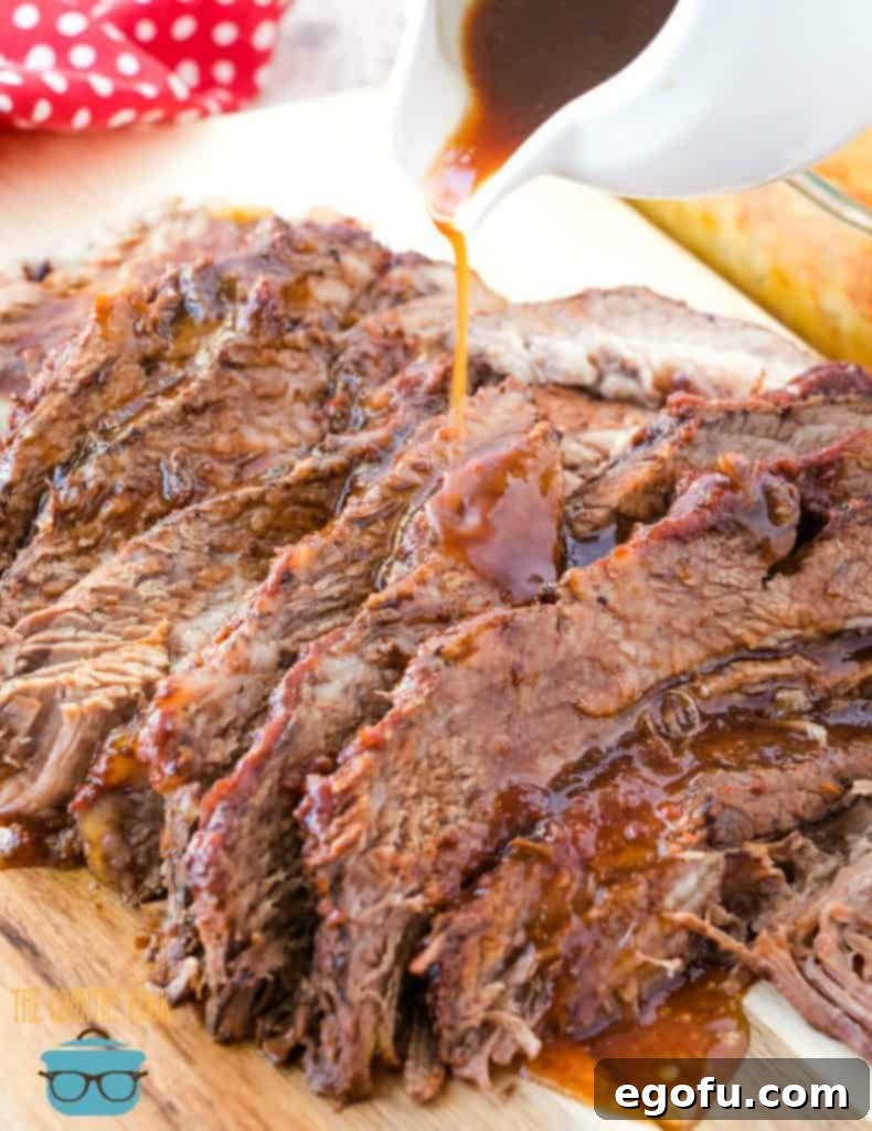 The Best Slow Cooker BBQ Beef Brisket with sauce on a serving platter