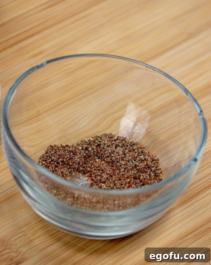 beef brisket rub seasoning ingredients in a bowl, chili powder, celery seed, pepper, garlic powder