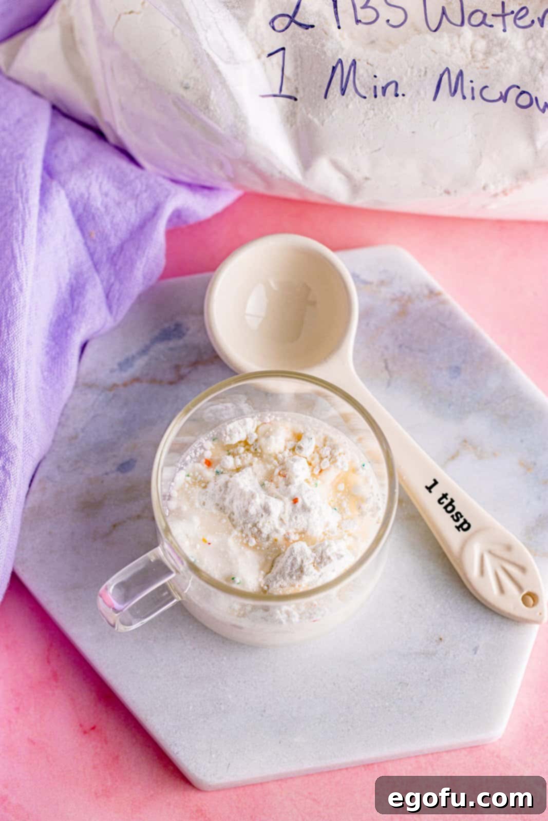Cake mix combined with water in a mug, ready for microwaving.