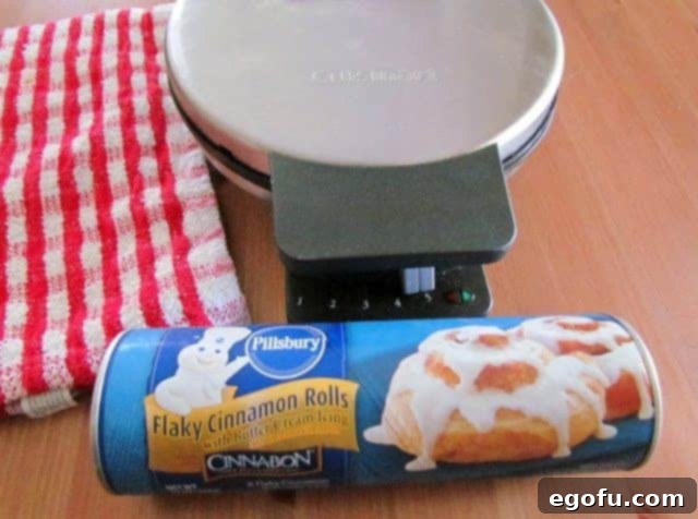 tube of cinnamon rolls with a Cuisinart waffle maker.