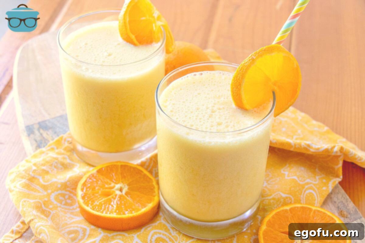 The Best Homemade Orange Julius 2 Copycat Orange Julius in glasses with sliced oranges.