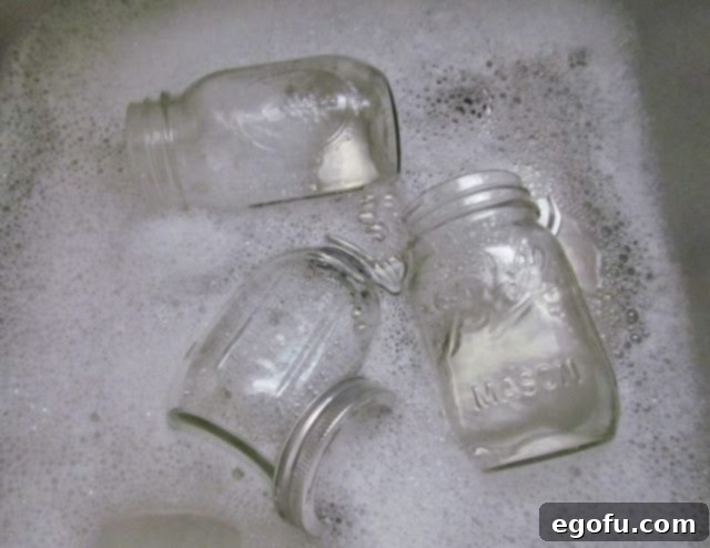 Sweet & Tangy Golden Slices 6 Clean pint-sized mason jars arranged neatly on a surface, signifying readiness for the pickling process.
