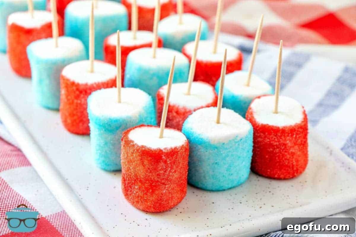 Patriotic Jell-O Marshmallows with toothpicks on a plate, ready to be served for a 4th of July celebration.