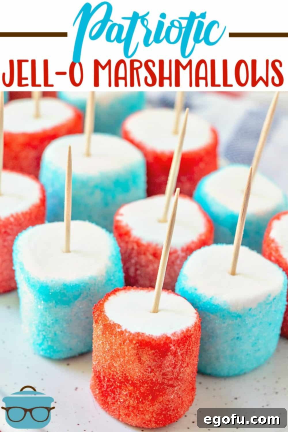 Patriotic Jell-O Marshmallows recipe from The Country Cook shown lined up on a white tray, showcasing the vibrant red and blue colors.