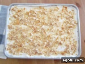 crushed vanilla wafers spread on top of cake.