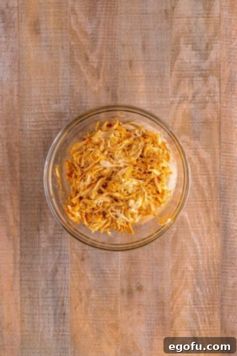 Effortless Slow Cooker Taco Chicken 14 shredded chicken in a bowl.