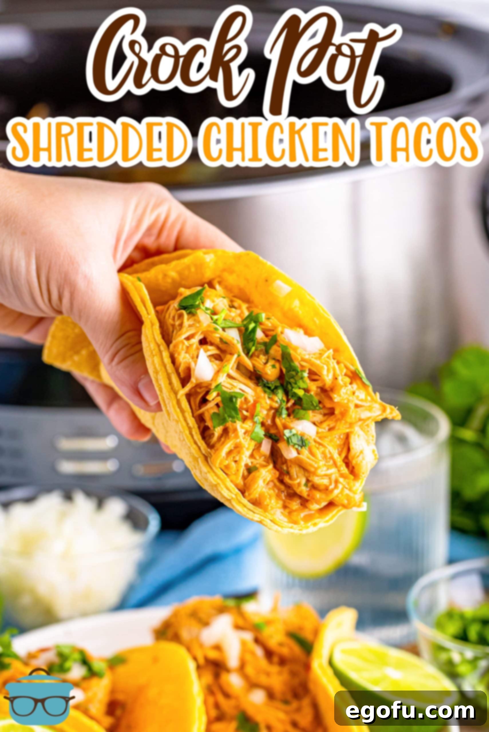 Effortless Slow Cooker Taco Chicken 3 A hand holding a large taco with Crockpot Shredded Chicken in it.