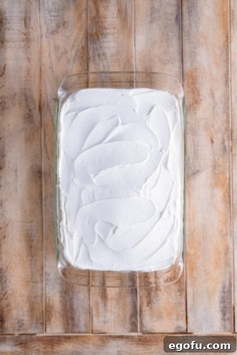 whipped cream spread over the baked cake.