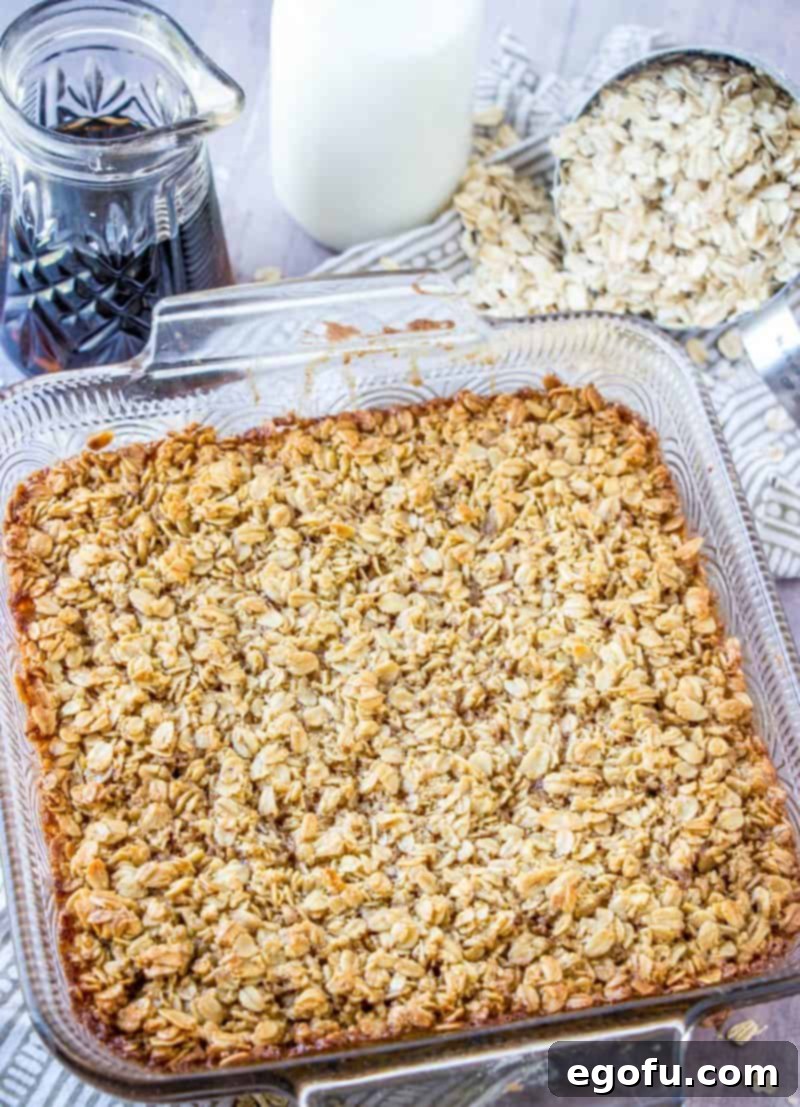 The golden-brown Maple and Brown Sugar Baked Oatmeal fresh out of the oven, steaming in its 2-quart baking dish, looking perfectly set and ready to be served.