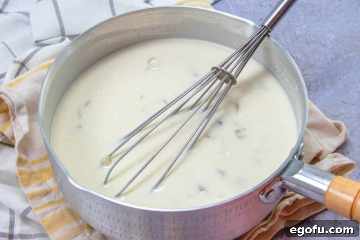 Decadent White Chicken Enchiladas 10 Sour cream and green chiles added to broth mixture in a sauce pan