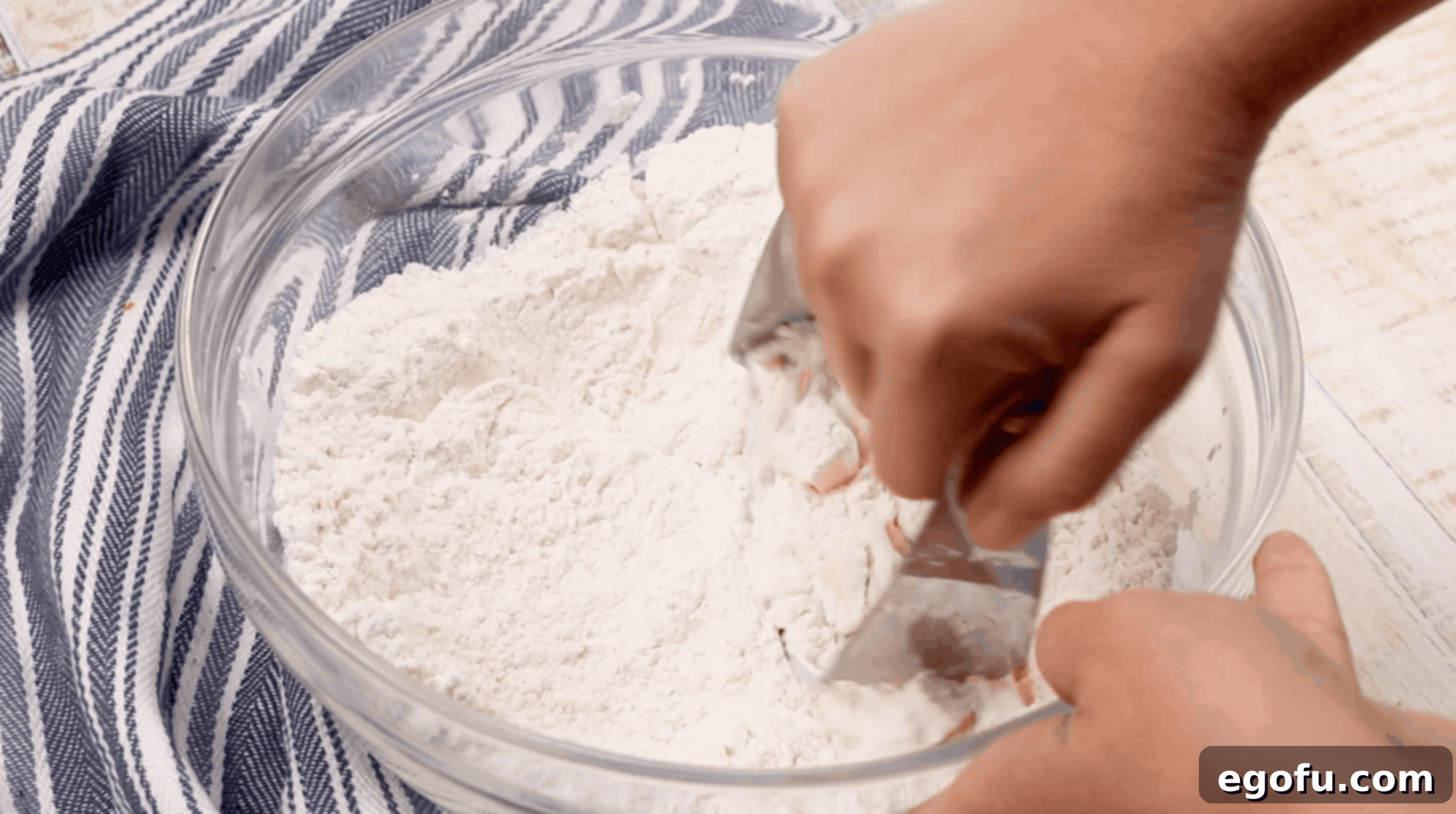 pastry cutter being used in a bowl of flour.