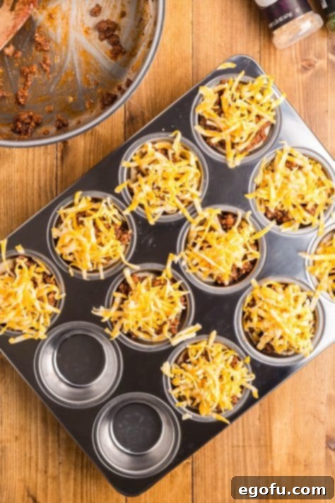 Smoky Beef Biscuit Pockets 15 Shredded cheese added to the tops of the biscuit cups.