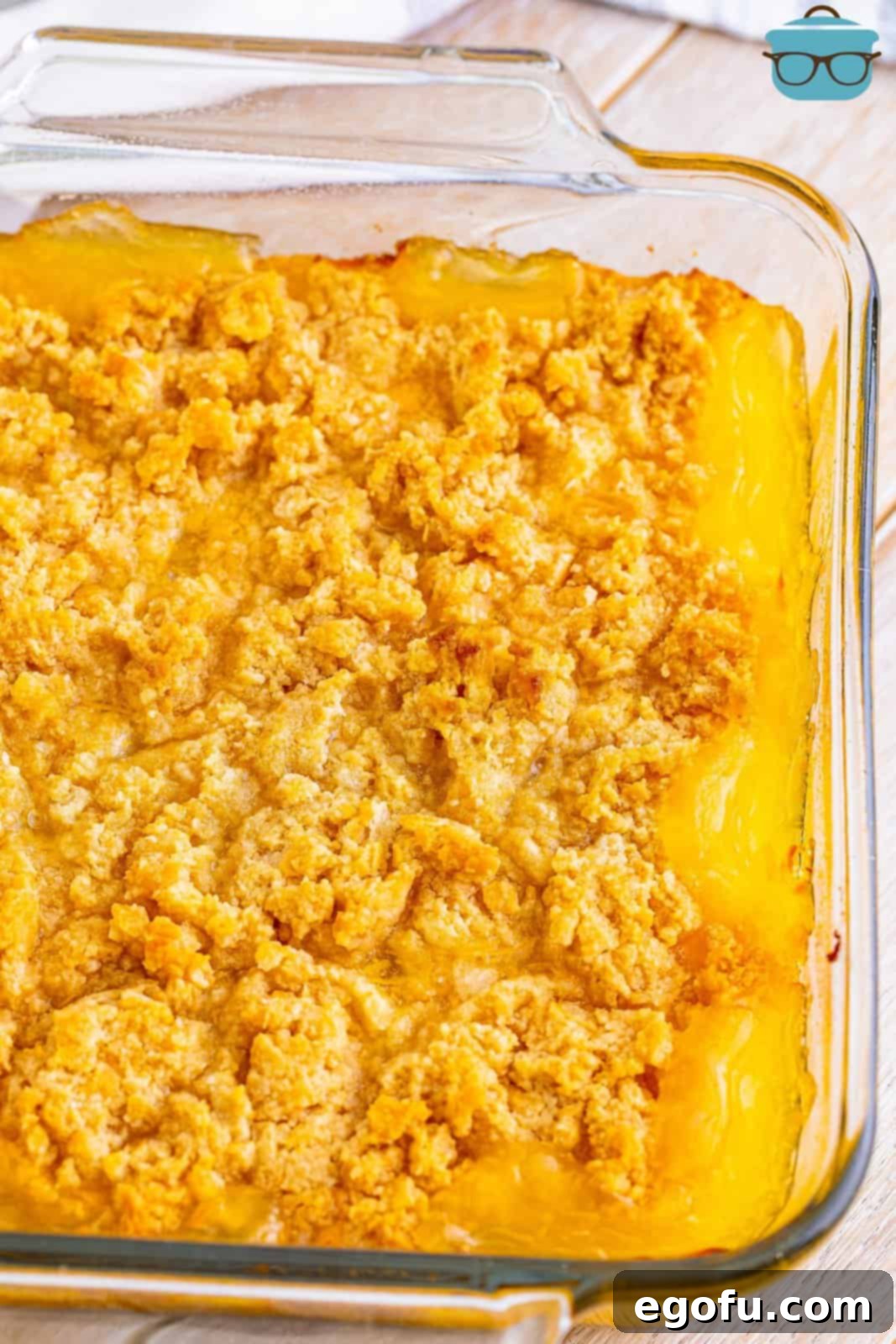 A fully baked pineapple casserole in a glass baking dish, with a perfectly golden-brown, crispy Ritz cracker topping.