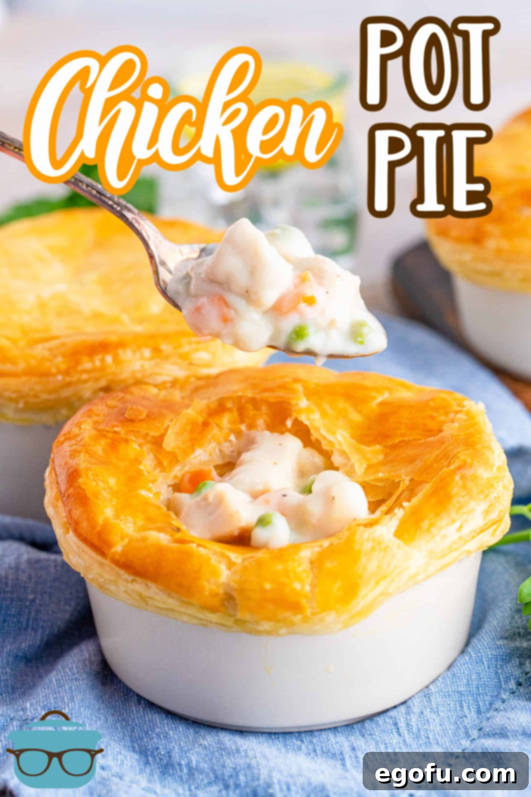 Individual Chicken Pot Pie served in a white ramekin, with a fork holding a bite of creamy filling and flaky crust, showcasing the rich texture.