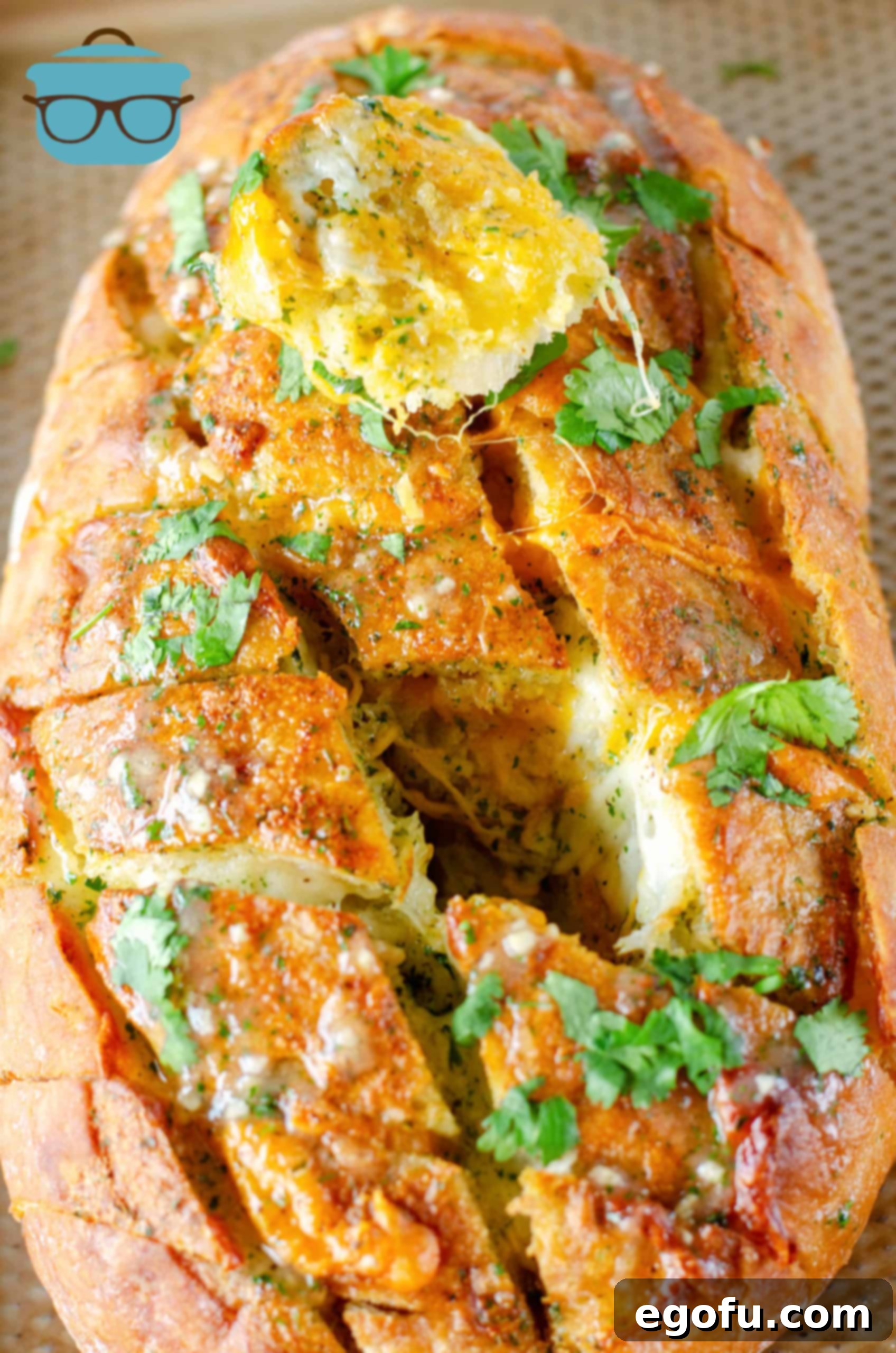 Ultimate Cheesy Bacon Ranch Pull Apart Delight 2 Cheesy Bacon Ranch Pull Apart Bread with one slice removed, showcasing melted cheese and bacon.