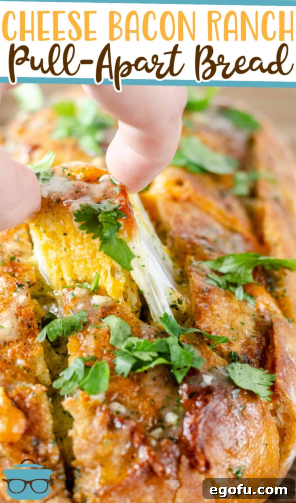 Ultimate Cheesy Bacon Ranch Pull Apart Delight 3 Close-up of a hand pulling a piece of Cheesy Bacon Ranch Pull-Apart Bread, showing melted cheese and bacon.