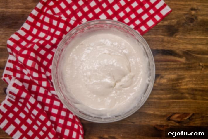 whipped topping added to cream cheese mixture in bowl.