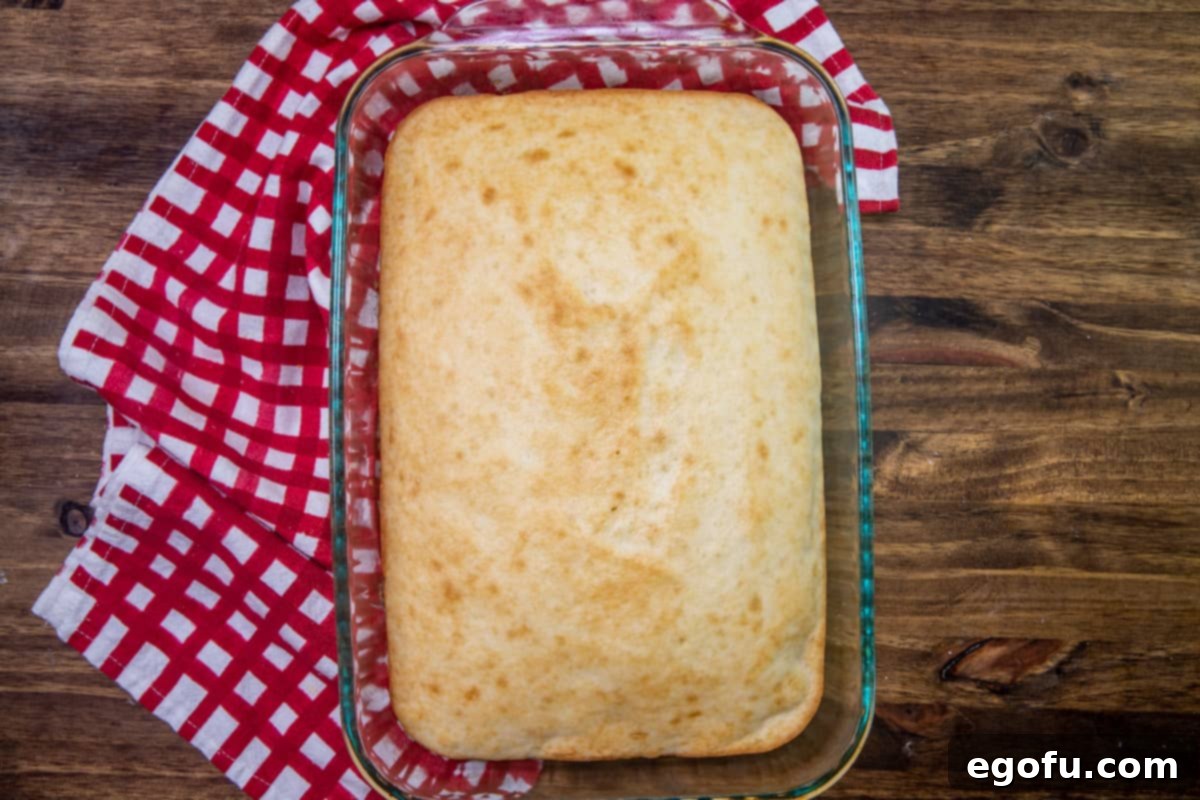 prepared white cake mix in a clear 9 by 13 baking dish.