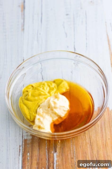 Dijon mustard, mayonnaise and honey in a bowl.