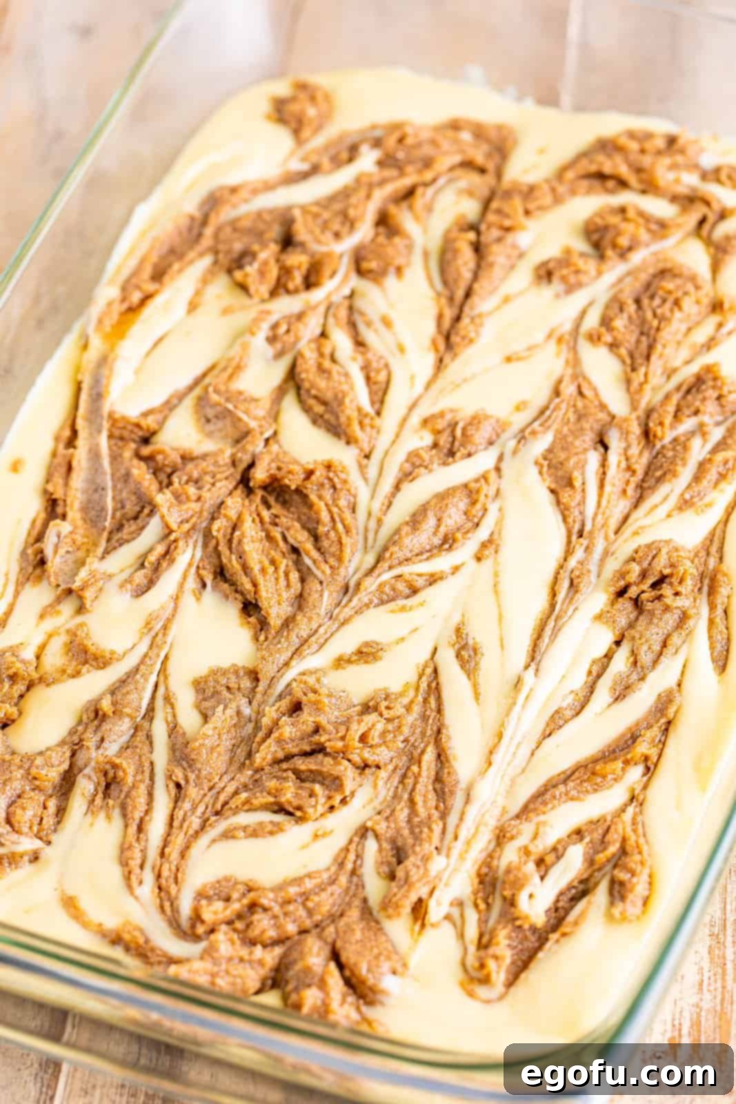 Swirl of Spice Cake 10 The cinnamon filling and cake batter are beautifully swirled together in the baking dish, creating an inviting marble pattern.
