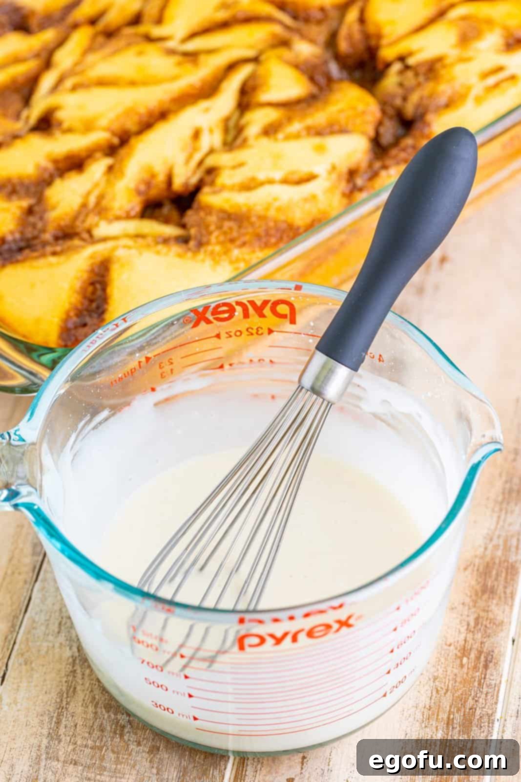 Swirl of Spice Cake 12 Preparing a smooth powdered sugar glaze in a measuring cup, whisked to perfection, ready to top the warm cake.