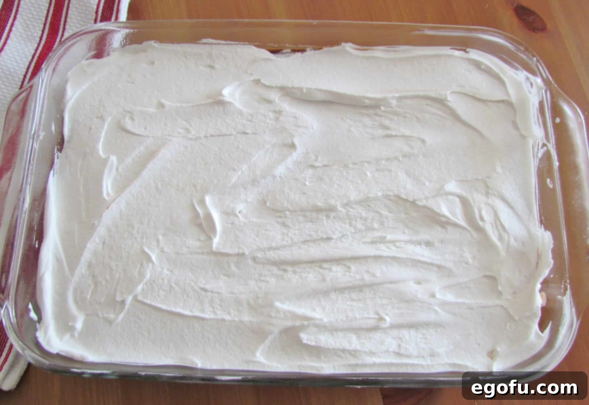 C Is For Cookie Layers 13 Cool Whip whipped topping spread on top of layered dessert.