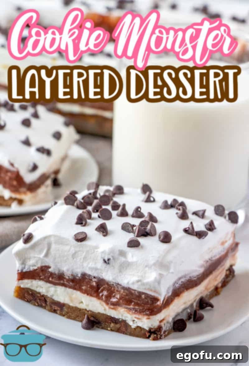 C Is For Cookie Layers 3 Cookie Monster Layered Dessert recipe from The Country Cook, slice shown on a small white plate with a clear glass of milk in the background.