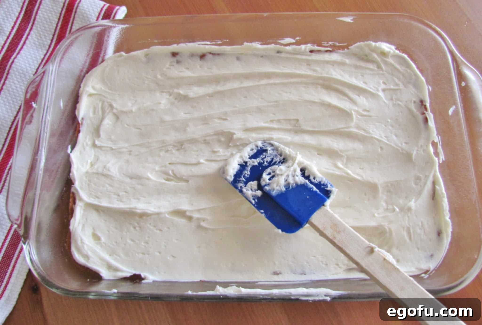 C Is For Cookie Layers 9 sweetened cream cheee spread on top of baked chocolate chip cookie layer.