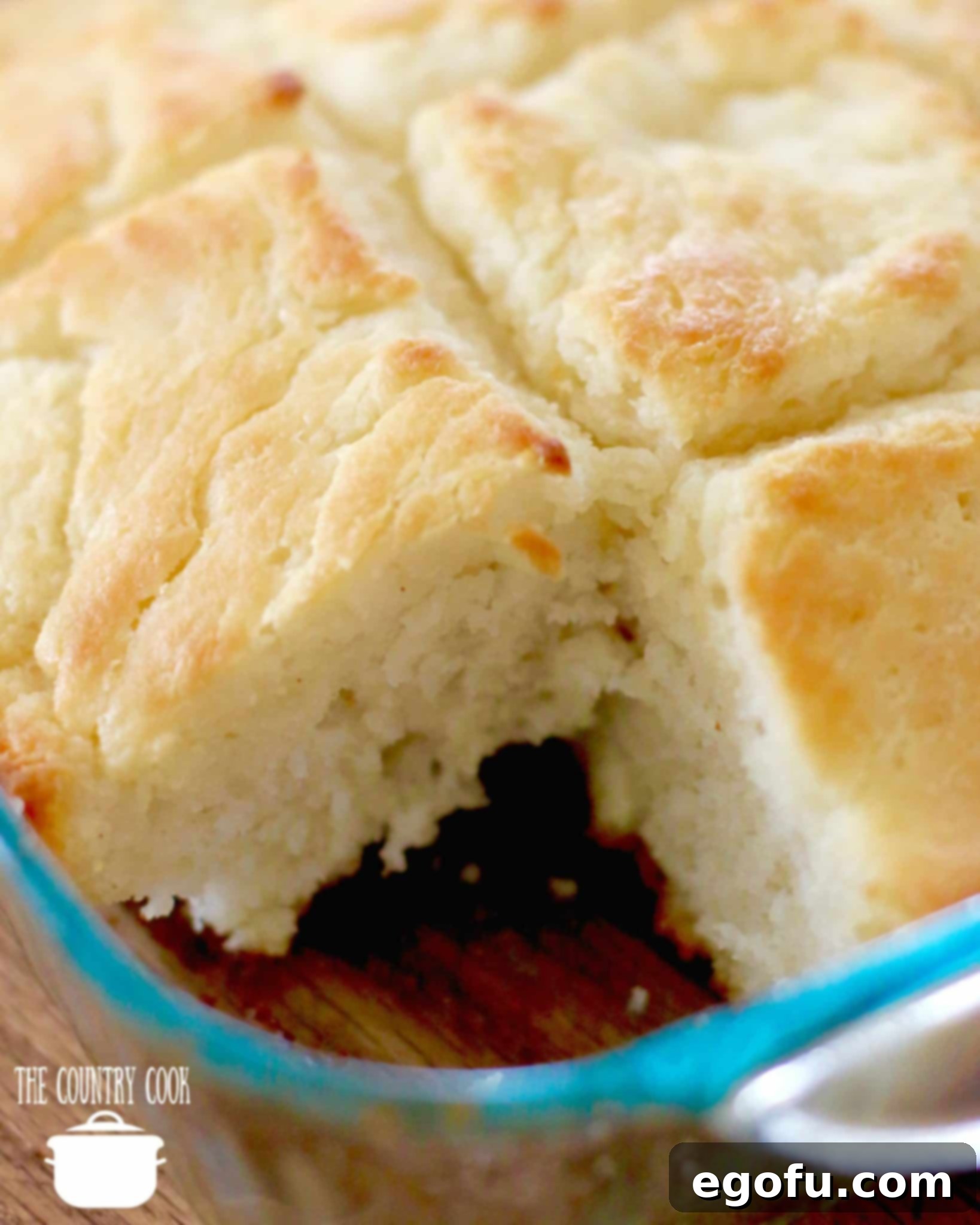 Golden Butter Biscuits 13 An easy Butter Dip Buttermilk Biscuit slice removed from the pan, showing its fluffy interior.