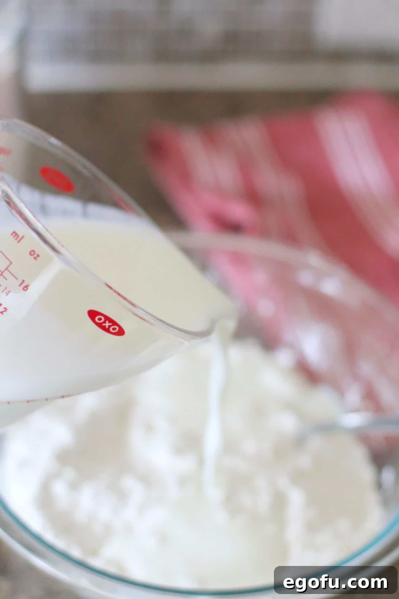 Golden Butter Biscuits 8 Whole fat buttermilk is gently poured into the flour mixture, ready to be combined into a dough.