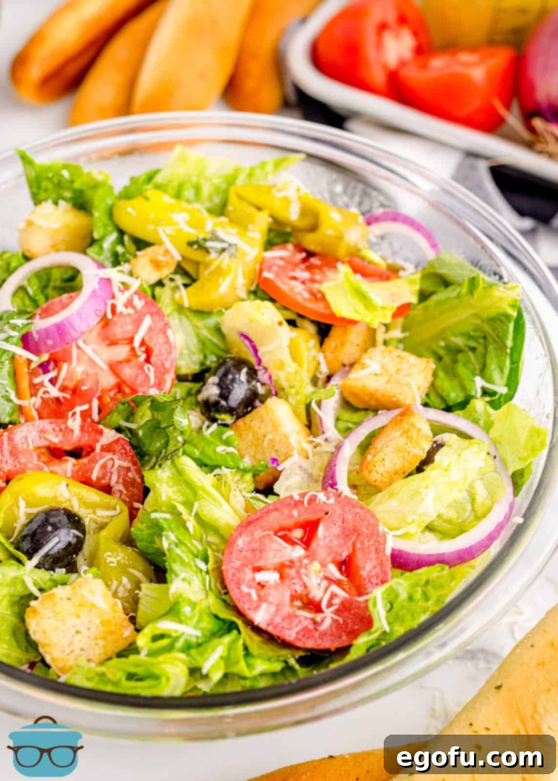 Homemade copycat Olive Garden Salad with dressing ready to be served.
