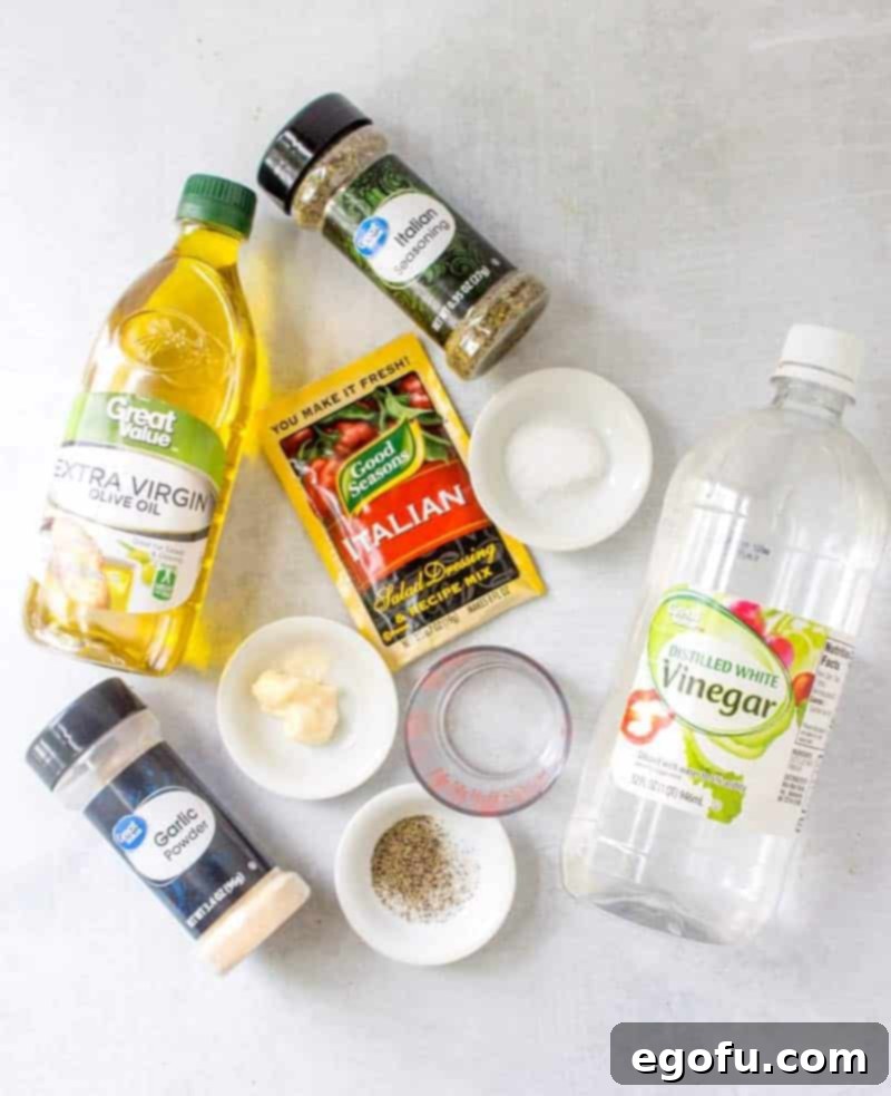 A visual display of all ingredients: Good Seasonings Italian Dressing packet, Italian Seasoning, table salt, black pepper, sugar, garlic powder, mayonnaise, olive oil, white vinegar, and water.
