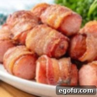 Crispy Bacon Brat Poppers 11 Bacon-Wrapped Sausage Bites on a plate